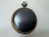 a black and gold pocket watch on a white surface