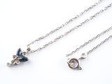 a close up of two necklaces on a white surface