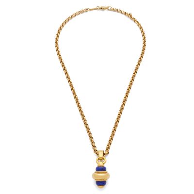 a gold necklace with a blue stone pendant on a gold chain