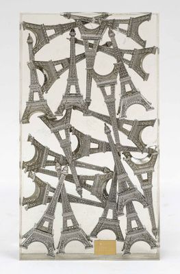 the eiffel tower is made out of newspaper and is displayed on a white surface
