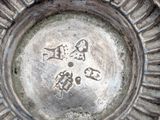 a close up of a silver plate with writing on it