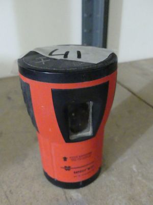an orange and black blender sitting on top of a floor next to a white wall
