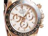 the rose gold rolex watch has a white dial and black rubber strap