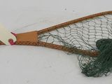 a tennis racket with a net attached to it in the snow