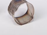 pair of silver cuff bracelets with engraved designs on them