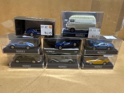 a lot of toy cars that are in a display case