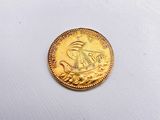 an image of a gold coin on a white cloth