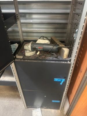 a black cabinet with a blow dryer on top of it