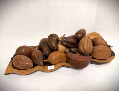a pile of nuts on a wooden plate on a table