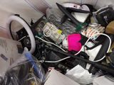 a pile of assorted items in a bin on the floor