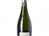 the bottle of champagne is sitting on a white surface