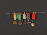 three medals hanging from a string on a black background