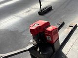 a forklift that is sitting on the side of the road