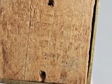 a person holding a wooden box with holes in it