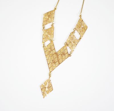 a gold necklace on a white background