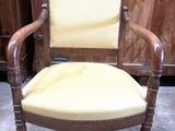 a wooden chair with a yellow upholstered seat