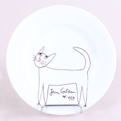 a white plate with a drawing of a cat on it