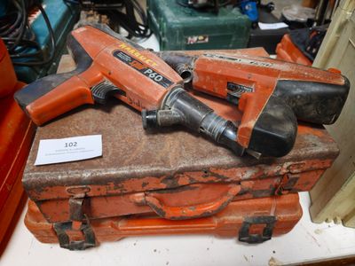 two tools sitting on top of a piece of luggage