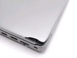 a close up of a laptop with a hole in the back of it