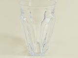 a clear glass cup sitting on a white surface