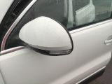 a white car with a mirror on the side of it