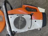 a chainsaw and a blower on the ground