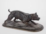 statue of a dog running on a base on a white background