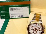 a rolex watch in a box with a card in it