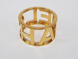 an image of a gold ring with the letter e on it