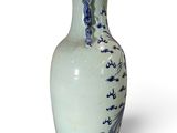 a blue and white vase sitting on a white surface
