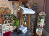 a desk with a lamp and a chair in a room