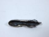 a metal object that is sitting on a white surface