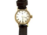 une montre en or avec des chiffres romains sur le cadran