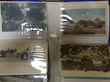 several old postcards are sitting in a case on a table