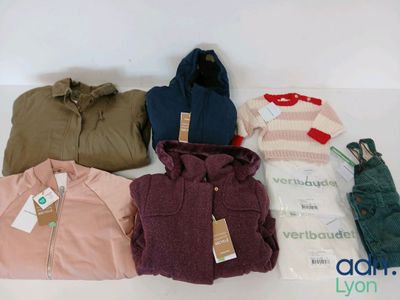 a lot of clothes that are sitting on a table