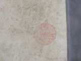 a red dot on the sidewalk of a building