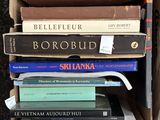 several books are stacked on top of each other in a box