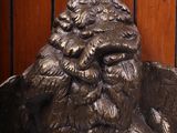 a statue of a man with a bird on it ' s head