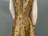 a mannequin wearing a yellow and black dress on a mannequin