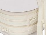 a close up of a spool of white zippers on a white background