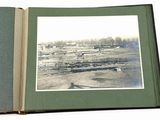 an open book with a picture of a farm in the background