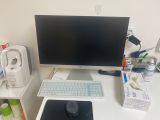 a computer desk with a monitor, keyboard and mouse on it