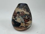 a vase with a picture of a man sitting on the ground