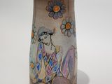 a vase that has a picture of a woman on it