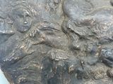 a close up of a metal plate with a bird on it