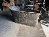 a large metal tub sitting in the middle of a garage