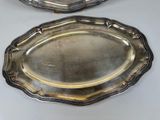pair of silver plated trays on a white table