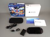 a box with a game controller and a charger on the table
