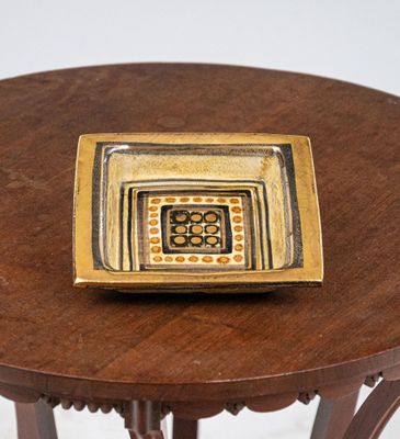 a small plate on a small table on a white background