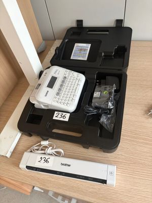 a black case with a keyboard and a remote on a table